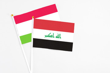 Iraq and Tajikistan stick flags on white background. High quality fabric, miniature national flag. Peaceful global concept.White floor for copy space.