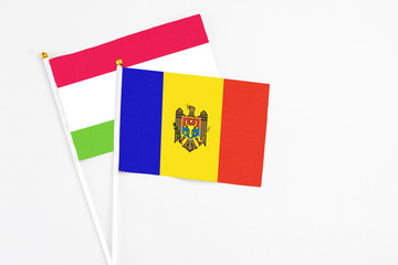 Moldova and Tajikistan stick flags on white background. High quality fabric, miniature national flag. Peaceful global concept.White floor for copy space.