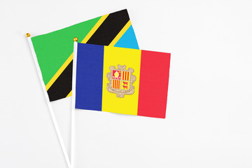 Andorra and Tanzania stick flags on white background. High quality fabric, miniature national flag. Peaceful global concept.White floor for copy space.