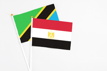 Egypt and Tanzania stick flags on white background. High quality fabric, miniature national flag. Peaceful global concept.White floor for copy space.
