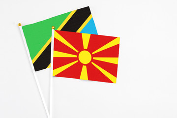 Macedonia and Tanzania stick flags on white background. High quality fabric, miniature national flag. Peaceful global concept.White floor for copy space.