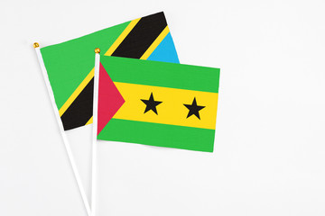 Sao Tome And Principe and Tanzania stick flags on white background. High quality fabric, miniature national flag. Peaceful global concept.White floor for copy space.