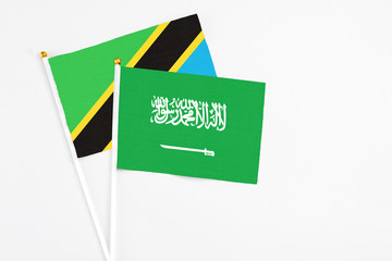 Saudi Arabia and Tanzania stick flags on white background. High quality fabric, miniature national flag. Peaceful global concept.White floor for copy space.