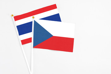 Czech Republic and Thailand stick flags on white background. High quality fabric, miniature national flag. Peaceful global concept.White floor for copy space.