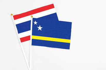 Curacao and Thailand stick flags on white background. High quality fabric, miniature national flag. Peaceful global concept.White floor for copy space.
