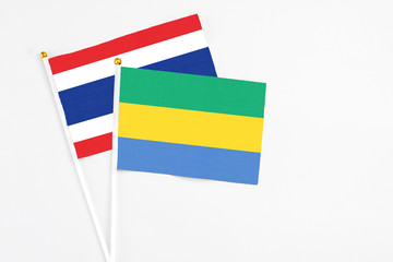 Gabon and Thailand stick flags on white background. High quality fabric, miniature national flag....
