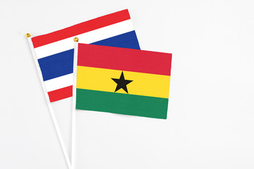 Ghana and Thailand stick flags on white background. High quality fabric, miniature national flag. Peaceful global concept.White floor for copy space.
