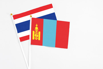Mongolia and Thailand stick flags on white background. High quality fabric, miniature national flag. Peaceful global concept.White floor for copy space.
