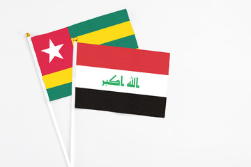 Iraq and Togo stick flags on white background. High quality fabric, miniature national flag....
