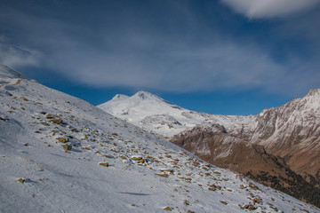 Mount Elbrus in the month of November. The mountains are covered with white snow. At the foot of mount Elbrus. Mountains for snowboarders and mountain skiers.
