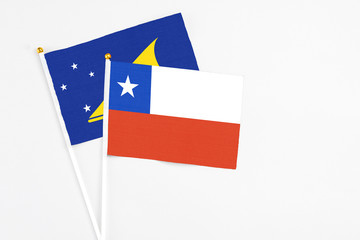 Chile and Tokelau stick flags on white background. High quality fabric, miniature national flag. Peaceful global concept.White floor for copy space.