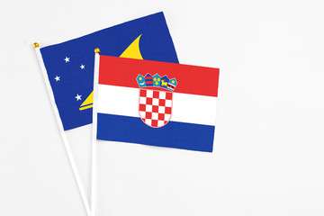 Croatia and Tokelau stick flags on white background. High quality fabric, miniature national flag. Peaceful global concept.White floor for copy space.