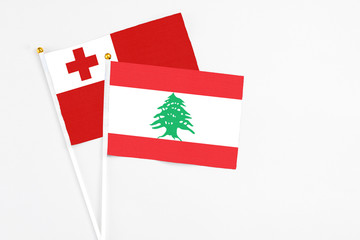 Lebanon and Tonga stick flags on white background. High quality fabric, miniature national flag....