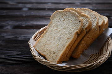 Fresh homemade  baked whole grain bread and sliced bread on wooden
