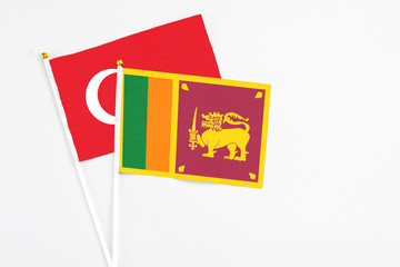 Sri Lanka and Turkey stick flags on white background. High quality fabric, miniature national flag. Peaceful global concept.White floor for copy space.