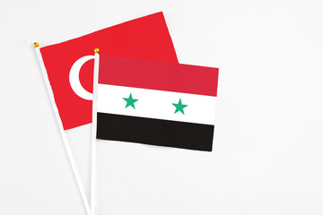 Syria and Turkey stick flags on white background. High quality fabric, miniature national flag. Peaceful global concept.White floor for copy space.