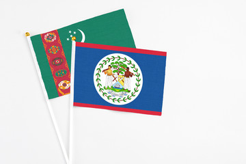 Belize and Turkmenistan stick flags on white background. High quality fabric, miniature national flag. Peaceful global concept.White floor for copy space.