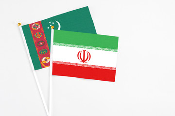 Iran and Turkmenistan stick flags on white background. High quality fabric, miniature national flag. Peaceful global concept.White floor for copy space.