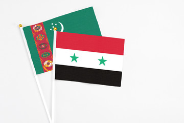 Syria and Turkmenistan stick flags on white background. High quality fabric, miniature national flag. Peaceful global concept.White floor for copy space.