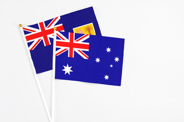 Fototapeta premium Australia and Turks And Caicos Islands stick flags on white background. High quality fabric, miniature national flag. Peaceful global concept.White floor for copy space.
