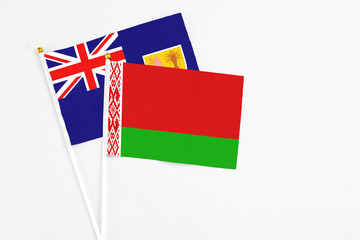 Belarus and Turks And Caicos Islands stick flags on white background. High quality fabric, miniature national flag. Peaceful global concept.White floor for copy space.