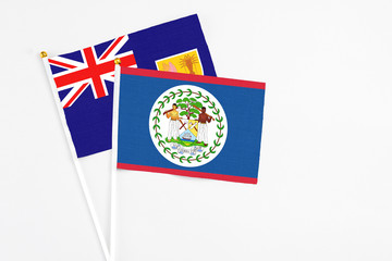 Fototapeta premium Belize and Turks And Caicos Islands stick flags on white background. High quality fabric, miniature national flag. Peaceful global concept.White floor for copy space.