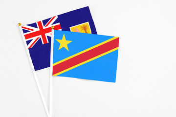 Congo and Turks And Caicos Islands stick flags on white background. High quality fabric, miniature national flag. Peaceful global concept.White floor for copy space.