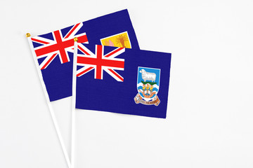 Falkland Islands and Turks And Caicos Islands stick flags on white background. High quality fabric,...