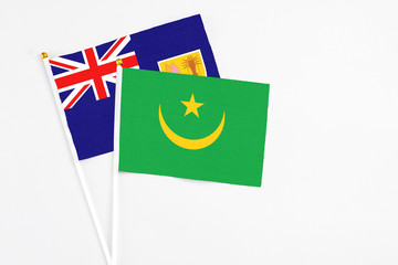Mauritania and Turks And Caicos Islands stick flags on white background. High quality fabric, miniature national flag. Peaceful global concept.White floor for copy space.