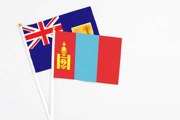 Mongolia and Turks And Caicos Islands stick flags on white background. High quality fabric, miniature national flag. Peaceful global concept.White floor for copy space.