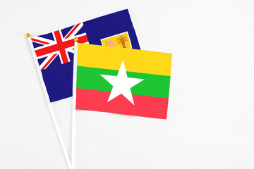 Myanmar and Turks And Caicos Islands stick flags on white background. High quality fabric, miniature national flag. Peaceful global concept.White floor for copy space.