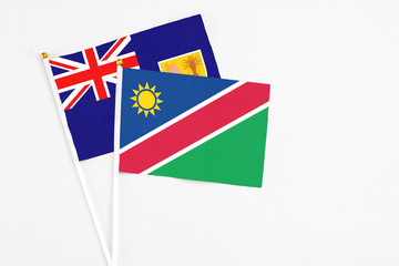 Namibia and Turks And Caicos Islands stick flags on white background. High quality fabric, miniature national flag. Peaceful global concept.White floor for copy space.