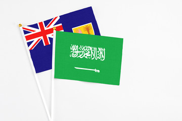 Saudi Arabia and Turks And Caicos Islands stick flags on white background. High quality fabric, miniature national flag. Peaceful global concept.White floor for copy space.