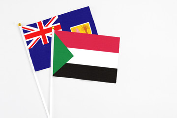 Sudan and Turks And Caicos Islands stick flags on white background. High quality fabric, miniature national flag. Peaceful global concept.White floor for copy space.