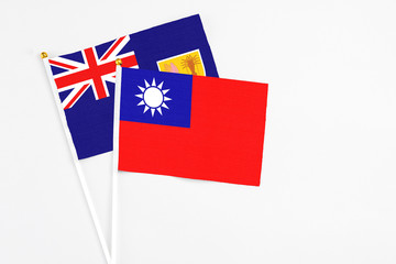 Fototapeta premium Taiwan and Turks And Caicos Islands stick flags on white background. High quality fabric, miniature national flag. Peaceful global concept.White floor for copy space.