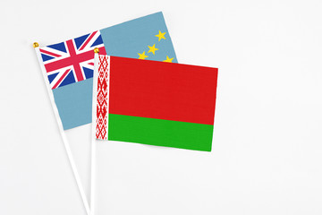 Belarus and Tuvalu stick flags on white background. High quality fabric, miniature national flag. Peaceful global concept.White floor for copy space.