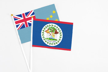 Belize and Tuvalu stick flags on white background. High quality fabric, miniature national flag. Peaceful global concept.White floor for copy space.