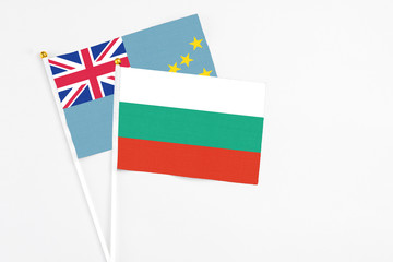 Bulgaria and Tuvalu stick flags on white background. High quality fabric, miniature national flag. Peaceful global concept.White floor for copy space.