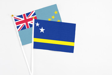 Curacao and Tuvalu stick flags on white background. High quality fabric, miniature national flag. Peaceful global concept.White floor for copy space.