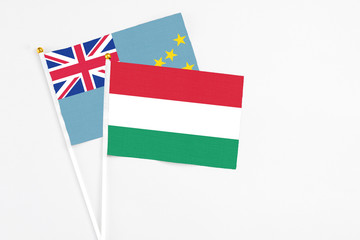 Hungary and Tuvalu stick flags on white background. High quality fabric, miniature national flag. Peaceful global concept.White floor for copy space.