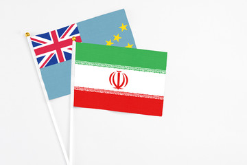 Iran and Tuvalu stick flags on white background. High quality fabric, miniature national flag. Peaceful global concept.White floor for copy space.