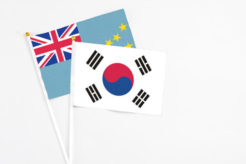 South Korea and Tuvalu stick flags on white background. High quality fabric, miniature national flag. Peaceful global concept.White floor for copy space.