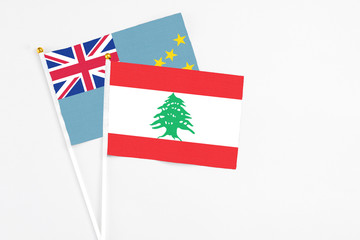 Lebanon and Tuvalu stick flags on white background. High quality fabric, miniature national flag. Peaceful global concept.White floor for copy space.
