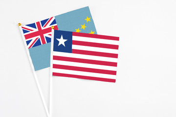 Liberia and Tuvalu stick flags on white background. High quality fabric, miniature national flag. Peaceful global concept.White floor for copy space.