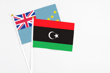 Libya and Tuvalu stick flags on white background. High quality fabric, miniature national flag. Peaceful global concept.White floor for copy space.