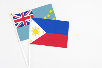 Philippines and Tuvalu stick flags on white background. High quality fabric, miniature national flag. Peaceful global concept.White floor for copy space.