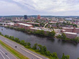 Fototapeta na wymiar Manchester downtown building including City Hall Plaza and Brady Sullivan Plaza with Merrimack River in the front aerial view, Manchester, New Hampshire, NH, USA.
