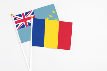 Romania and Tuvalu stick flags on white background. High quality fabric, miniature national flag. Peaceful global concept.White floor for copy space.
