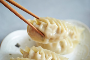 Boiled dumpling, holding with chopsticks 