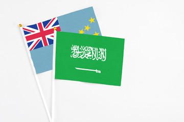 Saudi Arabia and Tuvalu stick flags on white background. High quality fabric, miniature national flag. Peaceful global concept.White floor for copy space.